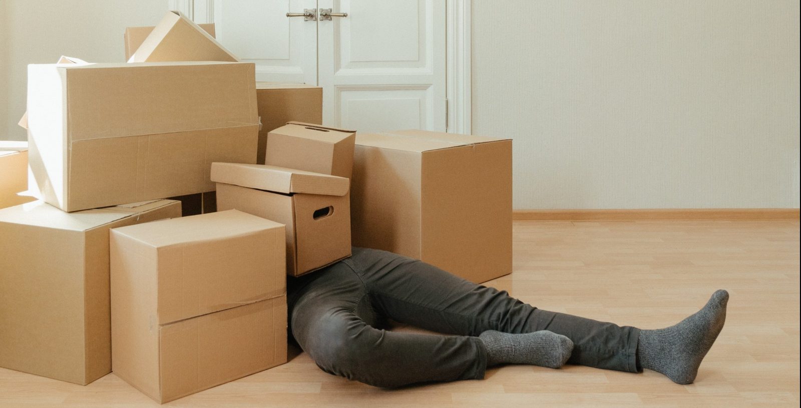 A person buried under a pile of boxes